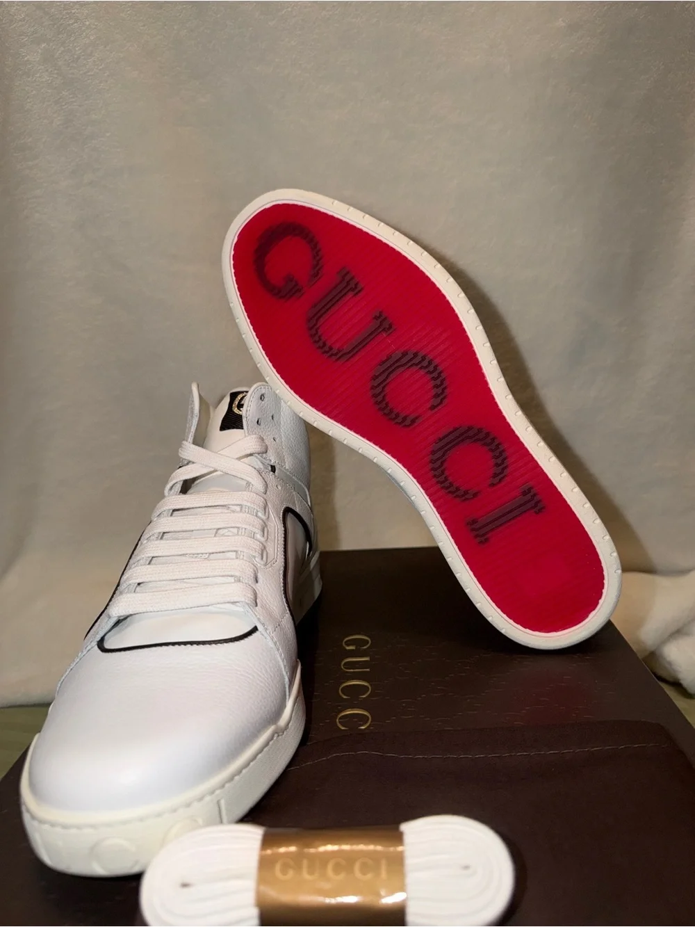 Gucci White Leather Low-Top Sneakers with Red Logo Sole.